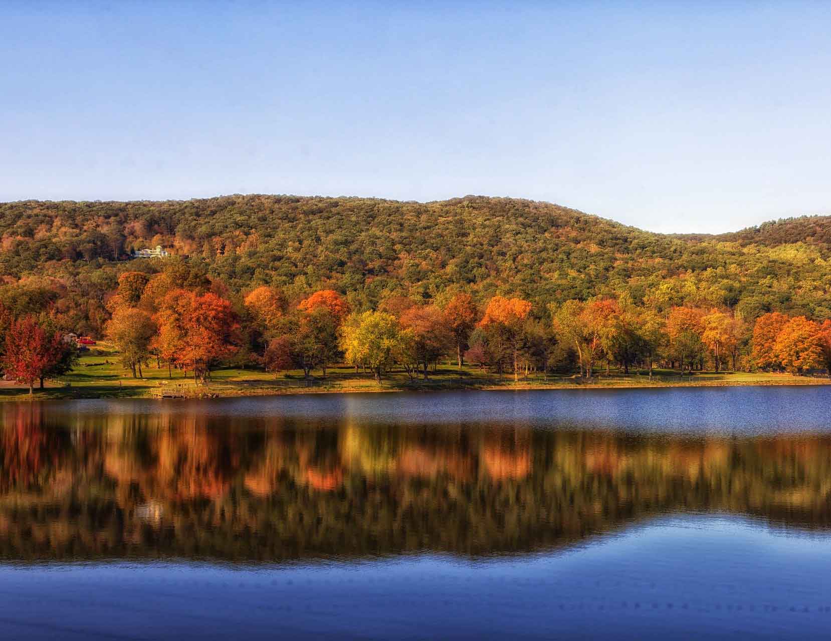 Beautiful Lake with Tree Covered Hills in Connecticut in Autumn.
