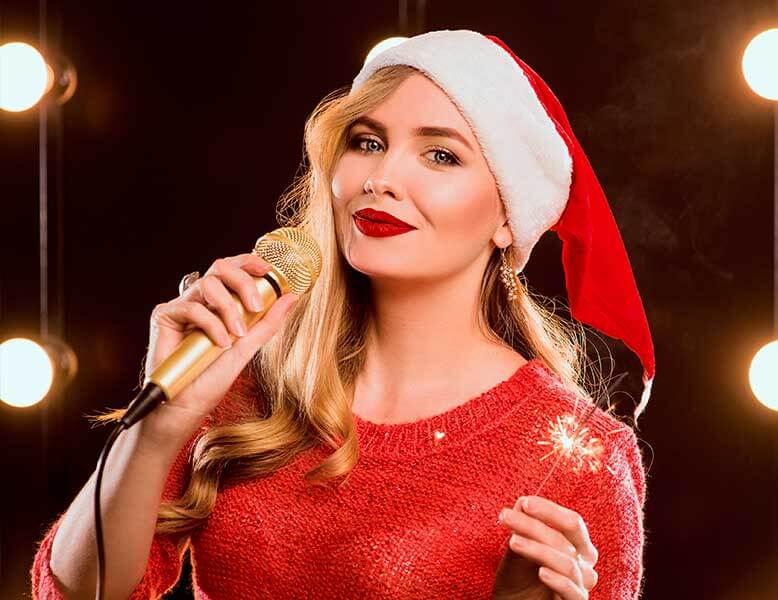Female Party Band Leader With Santa Hat Performing Live Music For A Corporate Holiday Party