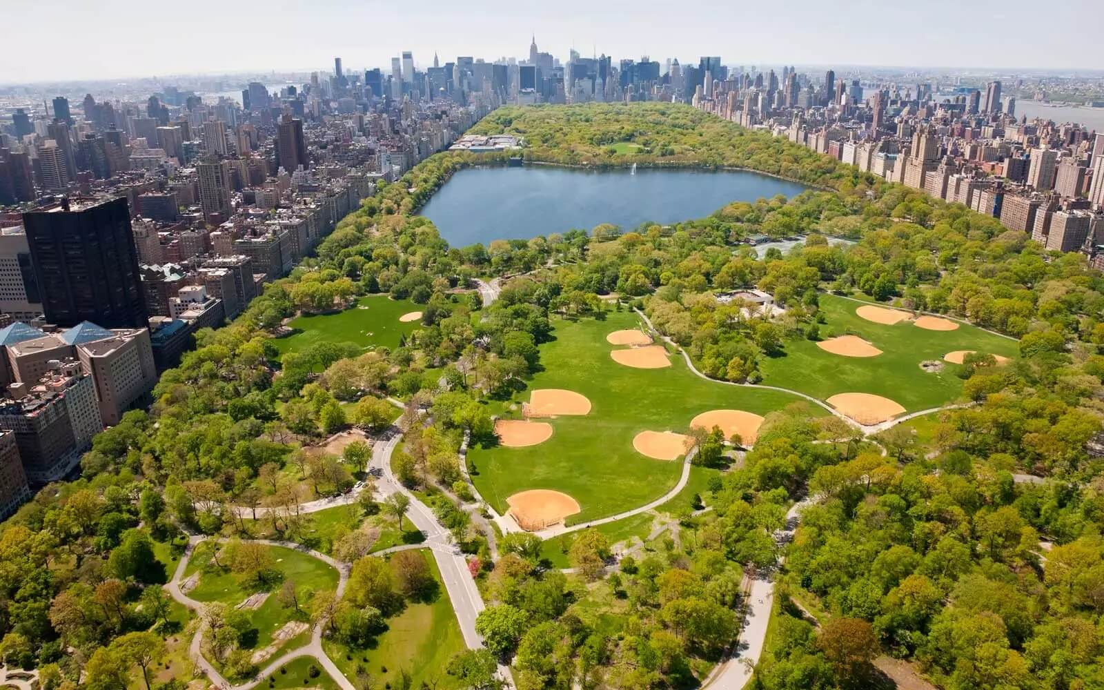 Central Park, Manhattan New York, NY - Aerial view in Summer of all of Central Park and the encircling skyline of buildings.