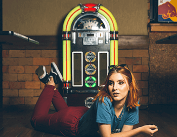young woman next to jukebox